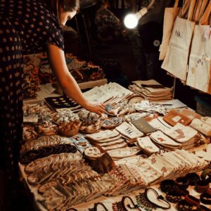 Anonymous woman buying traditional handmade souvenirs in market