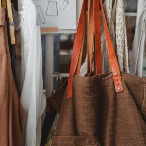 Assorted fabric bags on hooks in shop