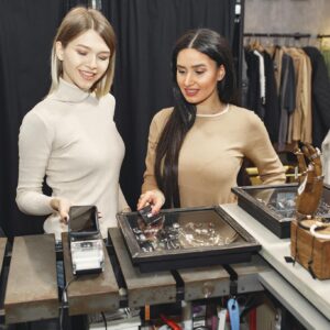 Women paying for clothes with smartphone